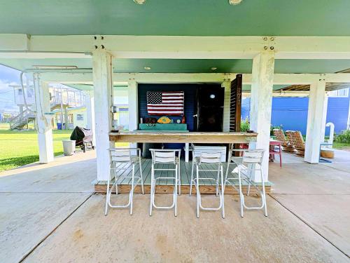an outdoor bar with chairs and an american flag at Surf & Turf Laid Back Slice of Island Life in Surfside Beach