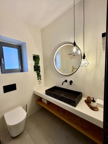 a bathroom with a sink and a mirror at Faragas Hill Harmony Villa in Angairiá