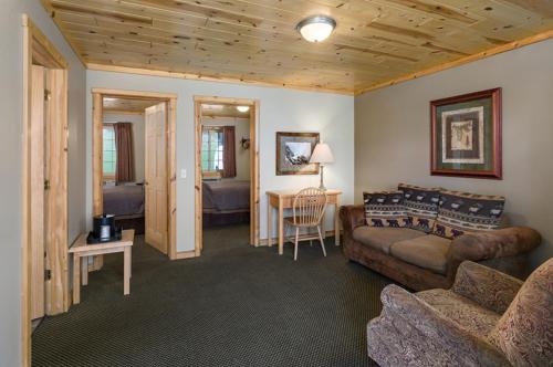 a living room with a couch and a table at Rock Crest Lodge & Cabins in Custer