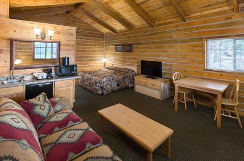a hotel room with a bed and a bed and a desk at Rock Crest Lodge & Cabins in Custer