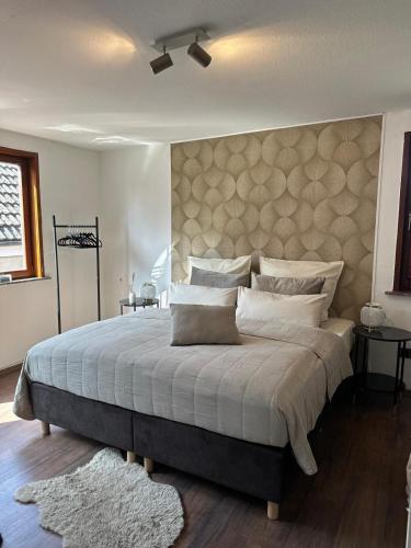 a bedroom with a large bed with a large headboard at Royal Haus Soltau in Soltau