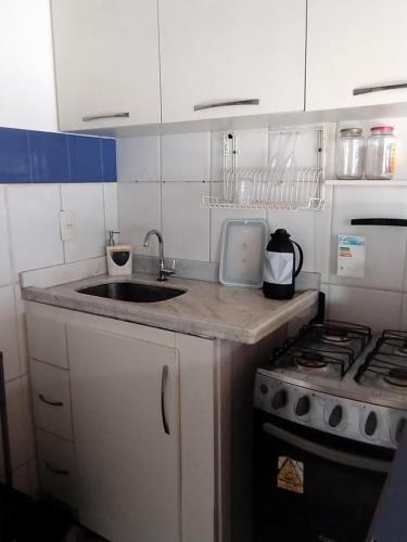 a kitchen with a sink and a stove at bela centro in Búzios