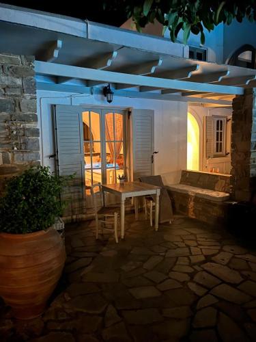 a table and chairs in a patio at night at Casa Paros in Parikia