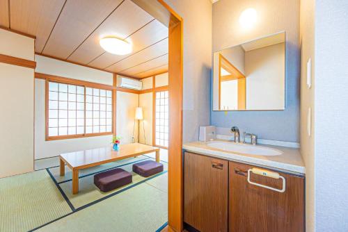 a bathroom with a sink and a mirror at Poka villa aoyama - Vacation STAY 19050 in Tokyo