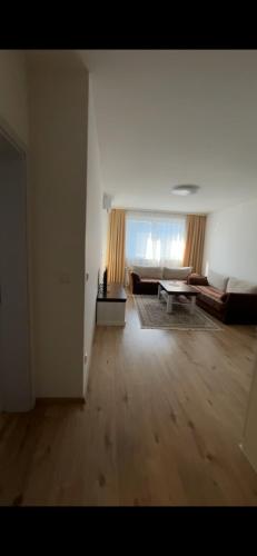 a living room with a couch and a table at 2BR apartment in Fushe Kosova in Kosovo Polje
