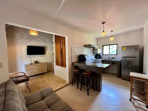 a kitchen and living room with a couch and a table at Hotel El Manglar in Playa Grande