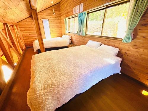 a bedroom with a bed in a wooden cabin at Ohana Inn - Vacation STAY 10994v in Kuka