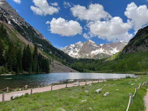 a road next to a lake in the mountains at Aspen Chalet 976 in Aspen