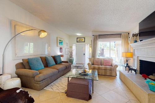 a living room with a couch and a fireplace at Oakmount Escape in Desert Hot Springs