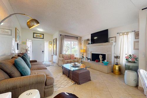 a living room with a couch and a fireplace at Oakmount Escape in Desert Hot Springs