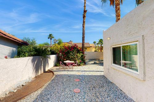 a patio with a table and chairs next to a building at Oakmount Escape in Desert Hot Springs