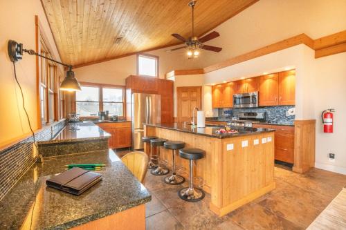 a large kitchen with a center island with bar stools at Kodak Moments By Avada Properties in Kodak