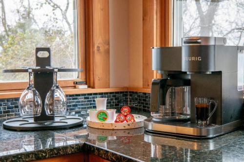 a kitchen counter with a coffee maker on top of it at Kodak Moments By Avada Properties in Kodak