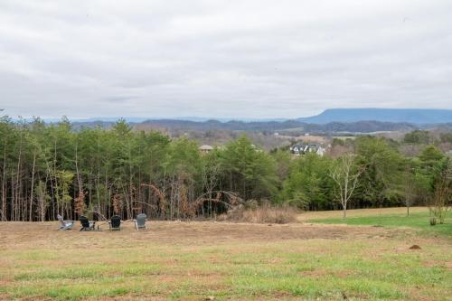 a group of people sitting in a field at Kodak Moments By Avada Properties in Kodak