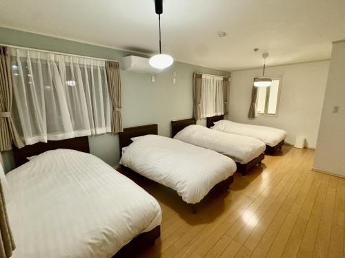 名古屋市にあるNagoya - House - Vacation STAY 19143の白いシーツが敷かれた部屋にベッドが3つ