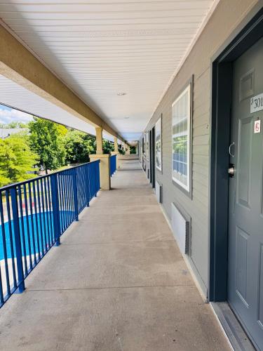 a hallway of a building with a blue door at Wander Inn in Branson