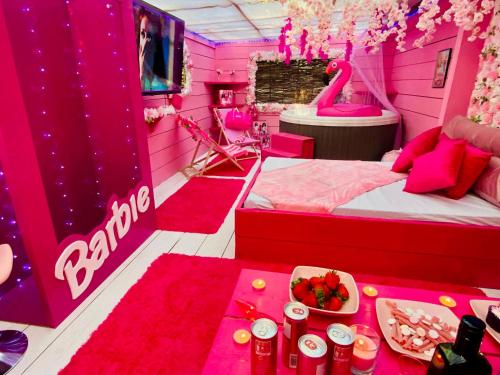 a pink room with a bed and a bowl of fruit at Sherwood Castle by Liv Retreats in Nottingham