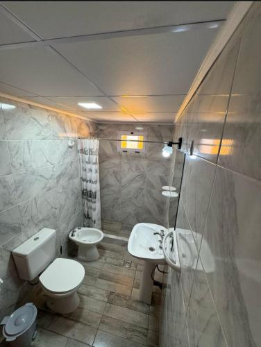 a bathroom with two toilets and a sink at CTA DIVISION House in Malargüe
