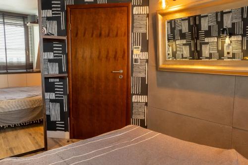 a room with a door and a bed and a mirror at Loft Świetego Mikołaja - Blisko Rynku - Klimatyzacja in Wrocław