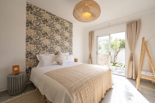 a bedroom with a large bed and a window at Ocean By La Siredrah in Wassane