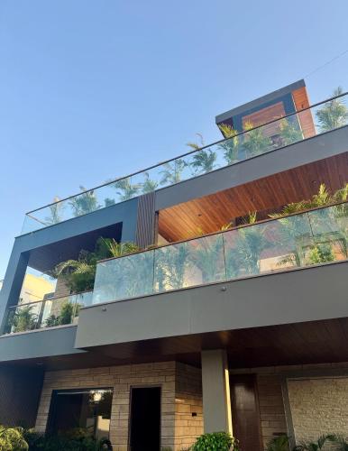 an apartment building with a balcony with plants at Skywood Villa Rooms in Lucknow