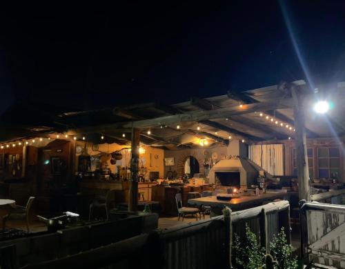 a patio with a table and a grill at night at Casablanca Overnight Accommodation and Camping in Brandvlei