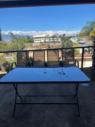 a blue ping pong table in front of a window at Nice and confortable 2 bedrooms apartment in Escazu in San Antonio