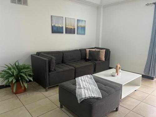 a living room with a couch and a coffee table at Nice and confortable 2 bedrooms apartment in Escazu in San Antonio