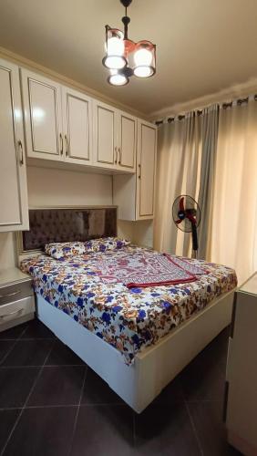 a bedroom with a bed with a quilt on it at PORTO MATROUH chalet families only in Marsa Matruh