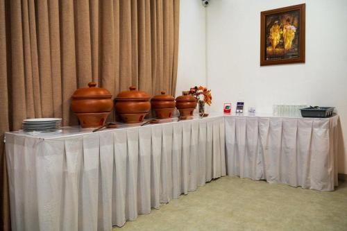 a table with vases sitting on top of it at Hanthana Heritage in Kandy