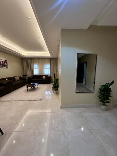 a large living room with a large mirror on the wall at قمم الخضراء 