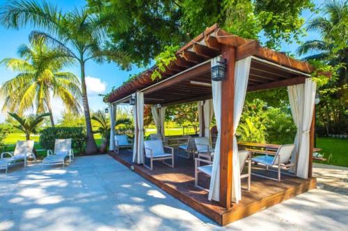 a wooden gazebo with chairs and a table at Las Gaviotas Hotel and Suites in Cancún