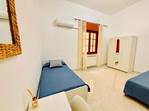 a room with two beds and a window at Da Liliana Apartment in Mazara del Vallo