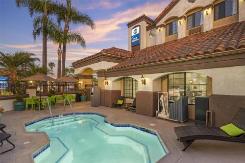 a villa with a swimming pool in a yard at Best Western Redondo Beach Galleria Inn Hotel - Beach City LA in Redondo Beach