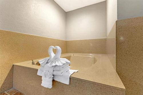 a bathroom with two swans sitting on a counter at Best Western Redondo Beach Galleria Inn Hotel - Beach City LA in Redondo Beach