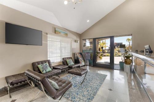 a living room with a couch and chairs and a flat screen tv at Best Western Redondo Beach Galleria Inn Hotel - Beach City LA in Redondo Beach