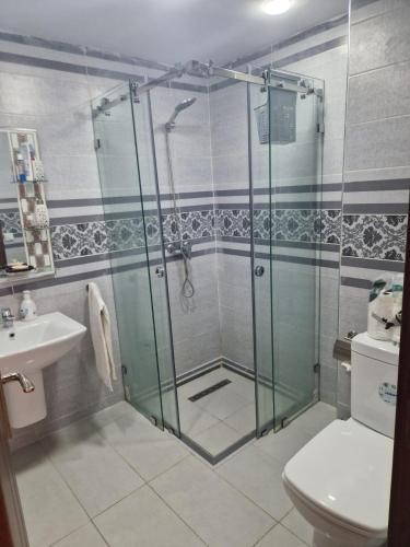 a bathroom with a shower and a toilet and a sink at الشروق 2 résidence chourouk 2 in Mansouria
