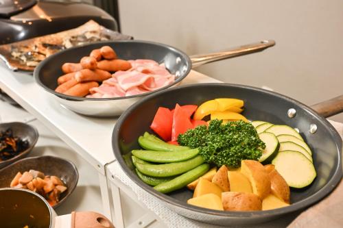 a pan filled with different types of vegetables on a counter at Sanco Inn Grande Tokyo Hamamatsucho in Tokyo