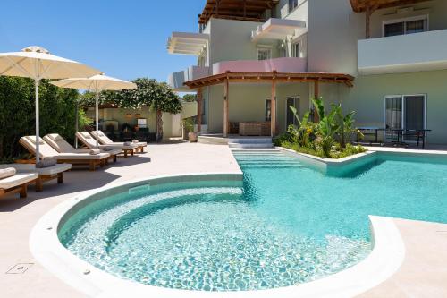a swimming pool in the middle of a house at Excelencia New Villa with Artistic Pool & Sea View in Asgourou