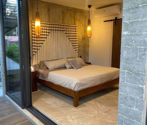 a bedroom with a bed in a room at Eco chic apartment in Tulum in Tulum