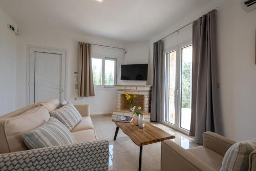 a living room with a couch and a table at Anima Horizon - Elia Villa 
