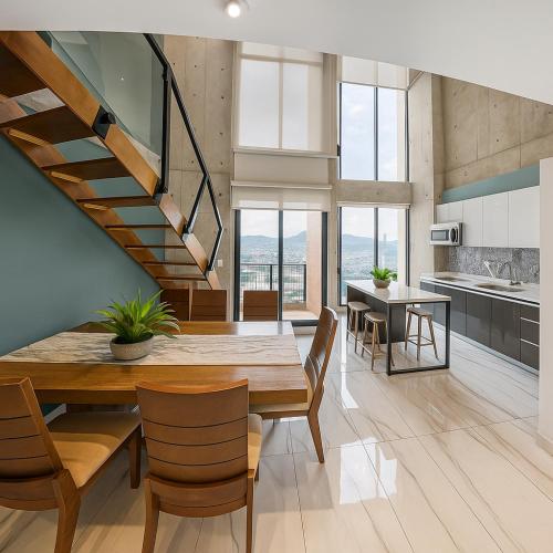 a kitchen and dining room with a wooden table and chairs at Luxury Loft Monterrey City Living at Landmark High Rise in Monterrey