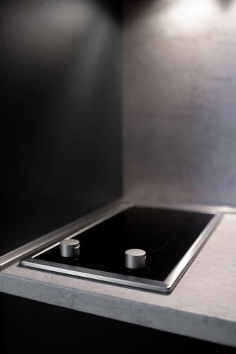 a black counter top with two knobs on it at Zafiro Apartment 21-29 in Kolašin