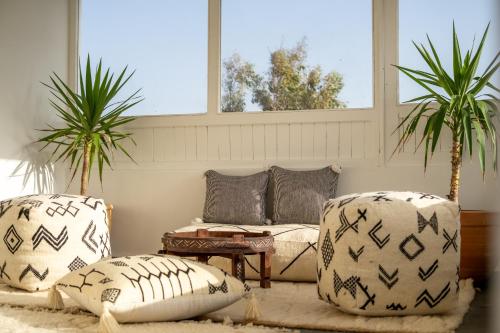 a living room with two chairs and a couch at Ocean By La Siredrah in Wassane
