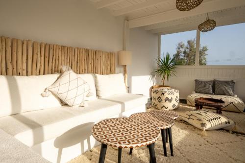 a living room with a white couch and a table at Ocean By La Siredrah in Wassane