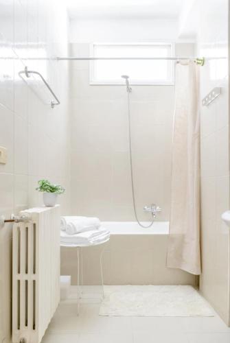 a white bathroom with a shower and a sink at Casa in centro con ampio giardino in Pescara