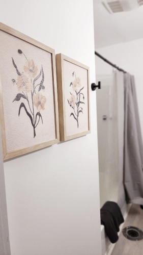 two framed drawings of flowers on a bathroom door at Grand Manor - Big 2 Bedroom - USA Side in Niagara Falls