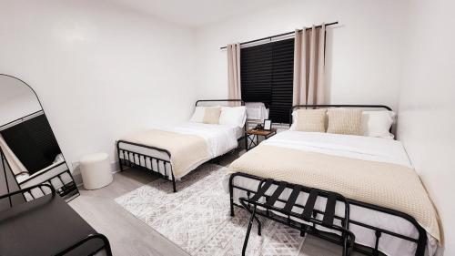 a bedroom with two beds and a window at Grand Manor - Big 2 Bedroom - USA Side in Niagara Falls