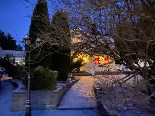 a house in the snow at night at DR ÅSA Apartment Penthouse w Pool by the Forest near a Golf course, Concerts and the Baltic Sea in Järna