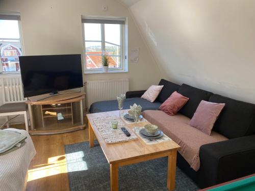 a living room with a couch and a table at DR ÅSA Apartment Penthouse w Pool by the Forest near a Golf course, Concerts and the Baltic Sea in Järna